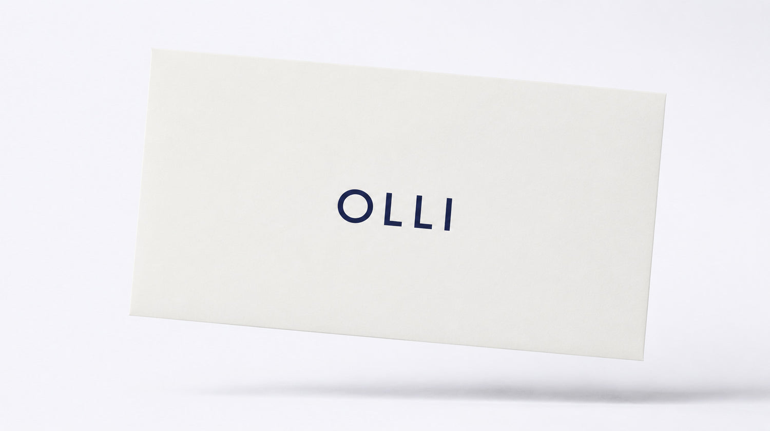 Rectangular white pillow with 'OLLI' branding on a white background