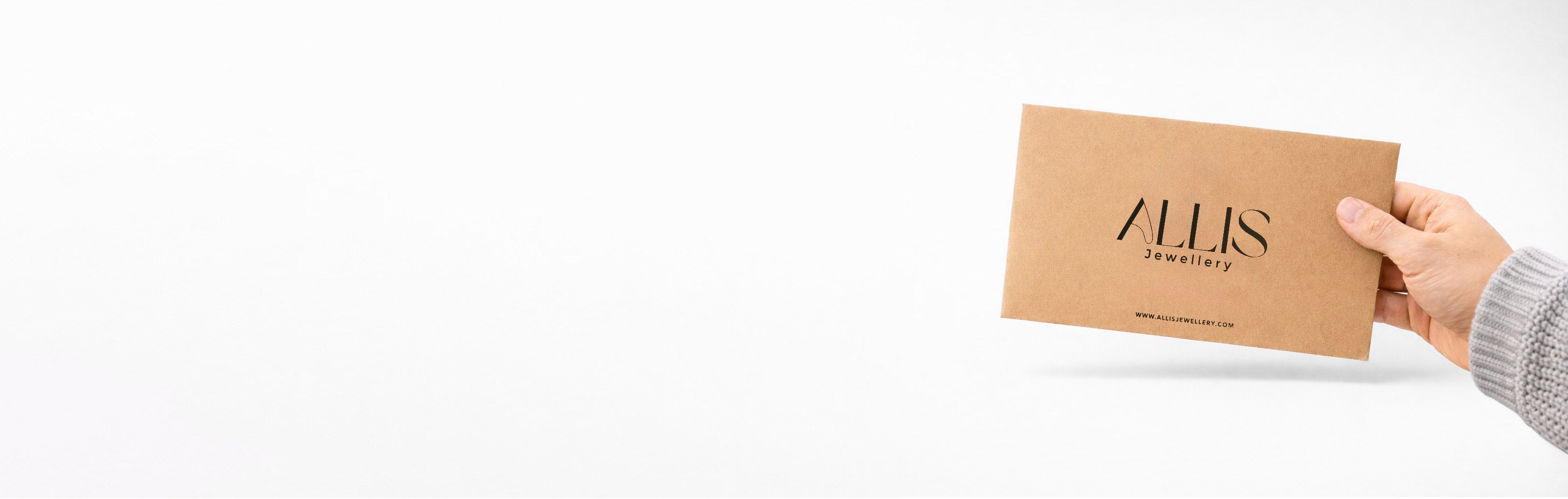 Hand holding a brown card with 'Allis' branding on a white background